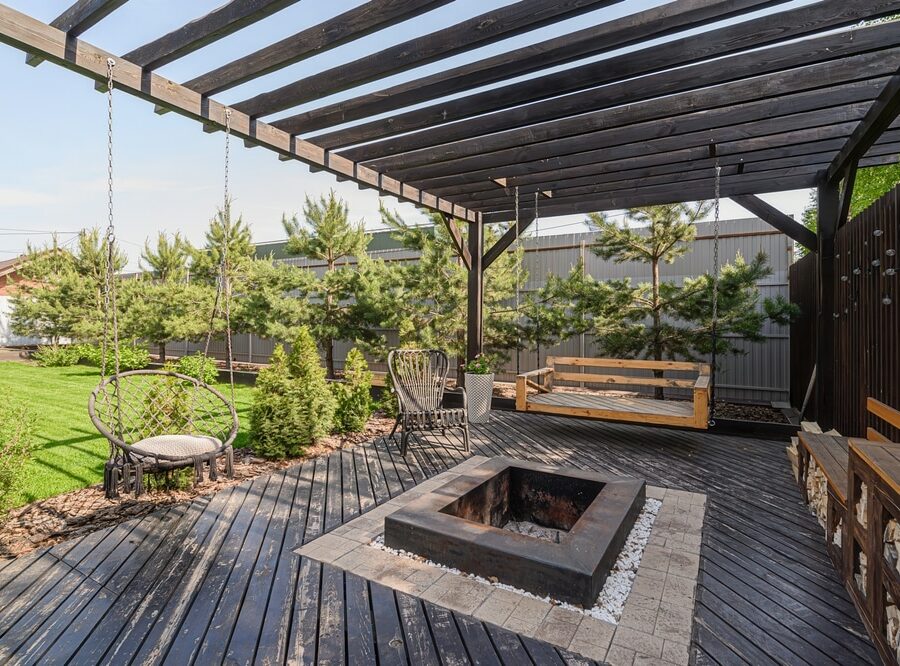 Cozy,Backyard,Patio,Featuring,A,Dark,Wood,Pergola,,Comfortable,Swing