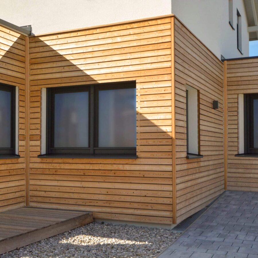 Wooden,Paneles,Natural,Modern,New,House,With,Windows,In,Summer