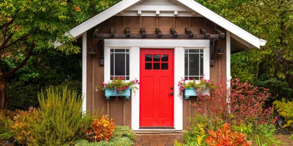 Small,Colorful,Wooden,Garden,Shed,With,A,Red,Door,And