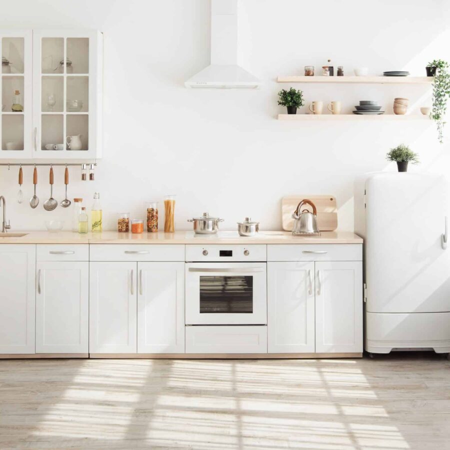 Kitchen,With,Light,Walls,,White,Furniture,And,Shelves,With,Crockery